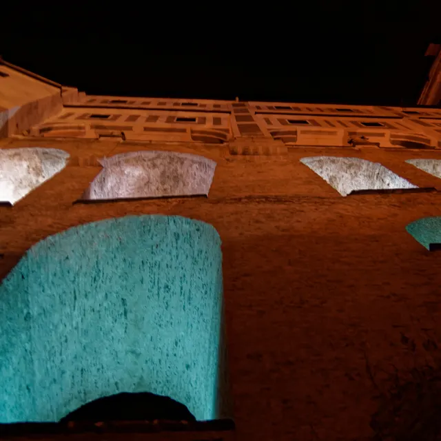 The Cloak Bridge of Český Krumlov Castle lit at night